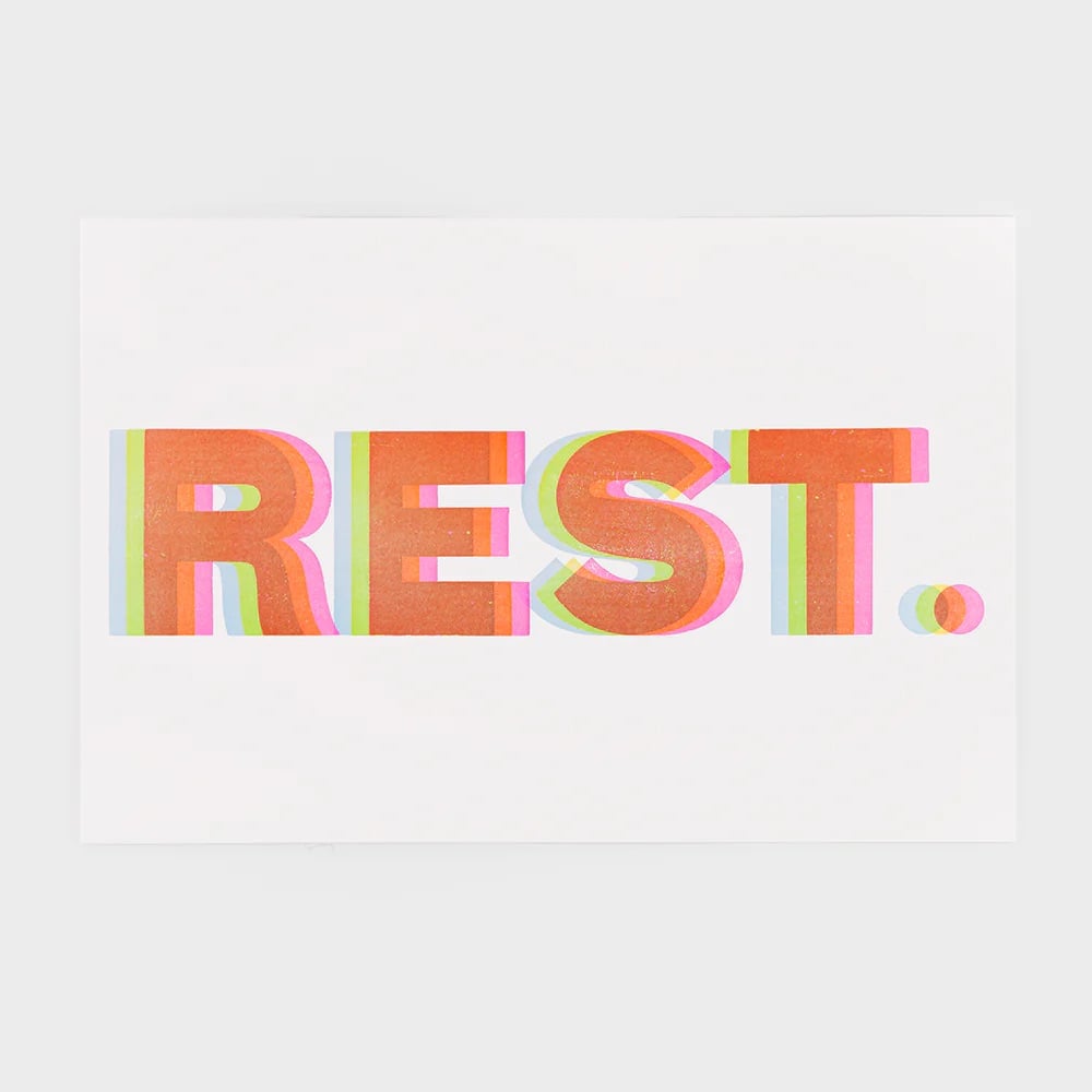 a print that says 'REST' in several overlapping colors