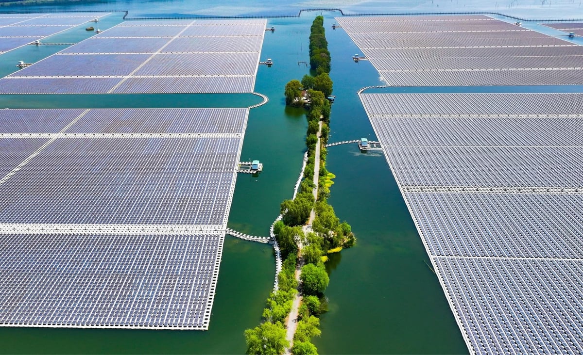 overhead view of a solar farm surrounded by water