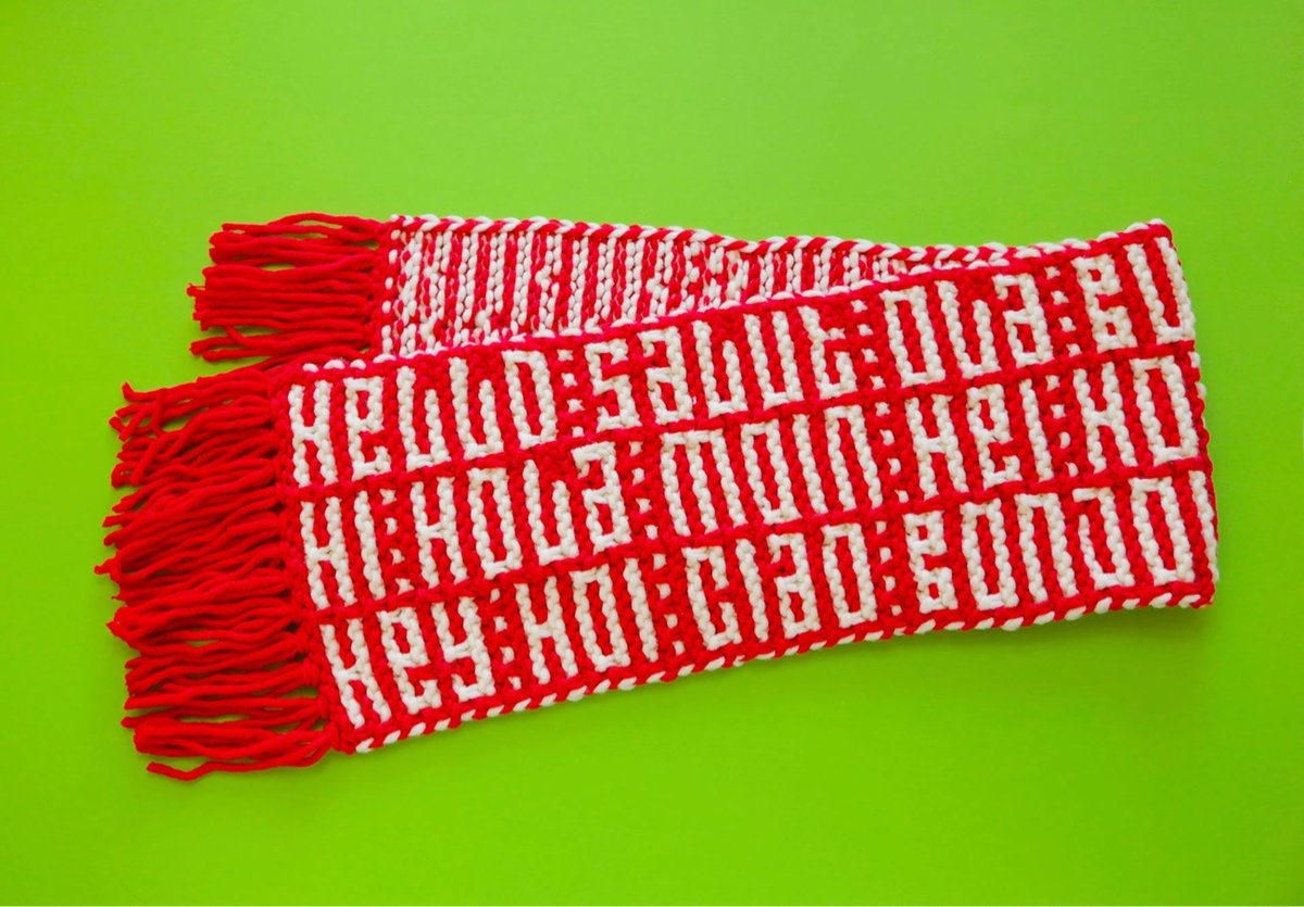 a scarf with a bunch of knitted words for 'hello' in different languages