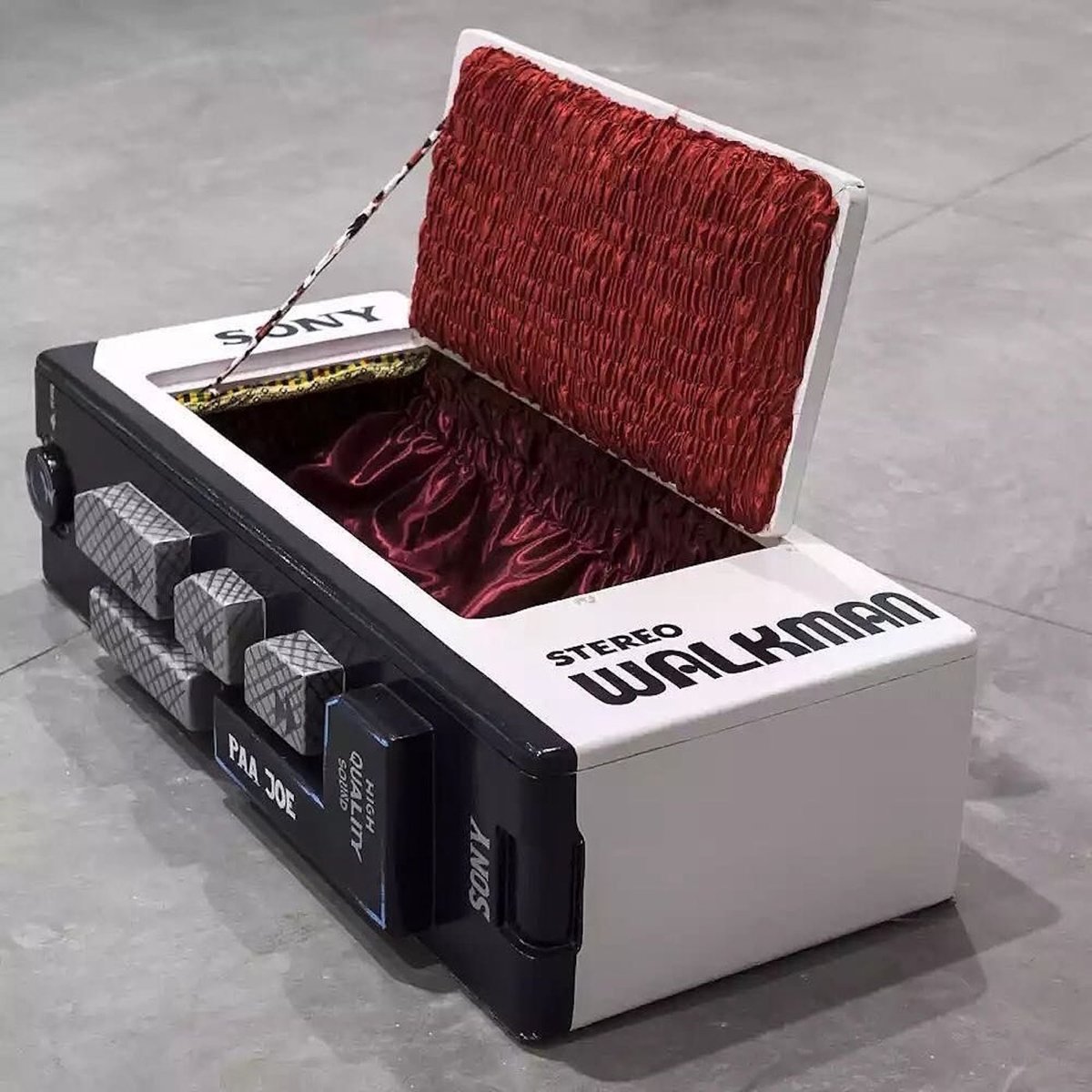 a human-sized coffin shaped like a Sony Walkman