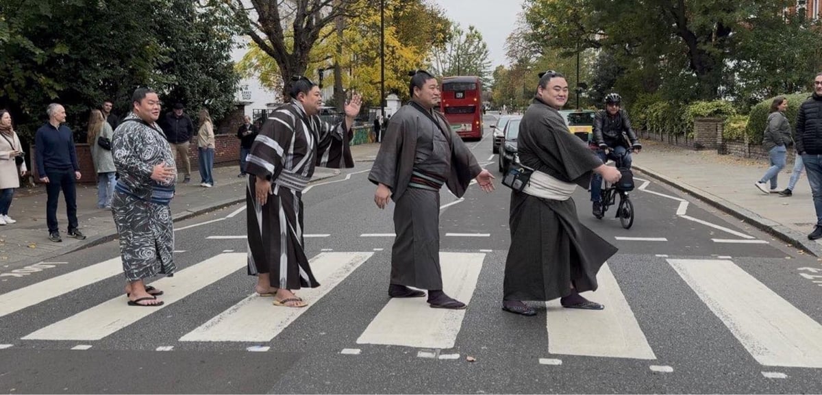 group of sumo wrestlers doing the Beatles Abbey Road walk