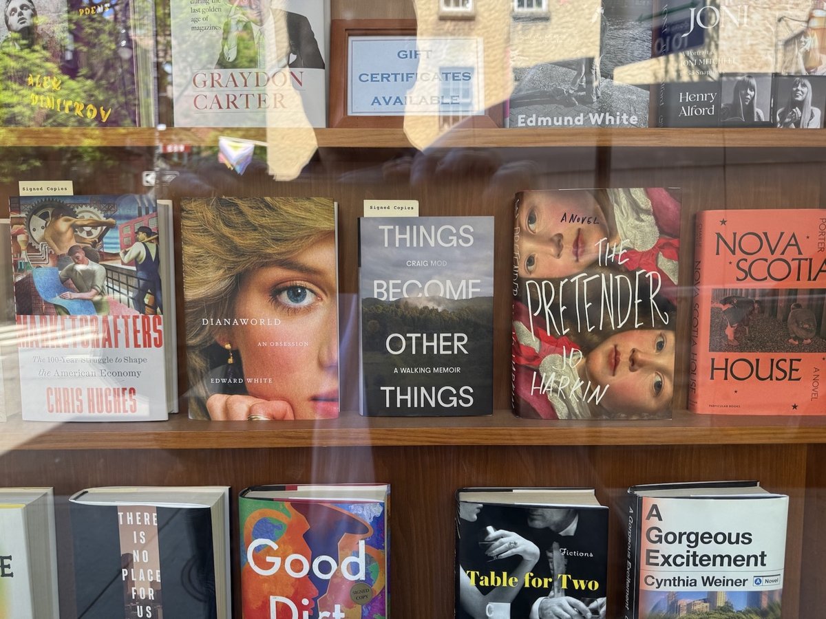 a signed copy of Things Become Other Things by Craig Mod in the window of Three Lives bookstore