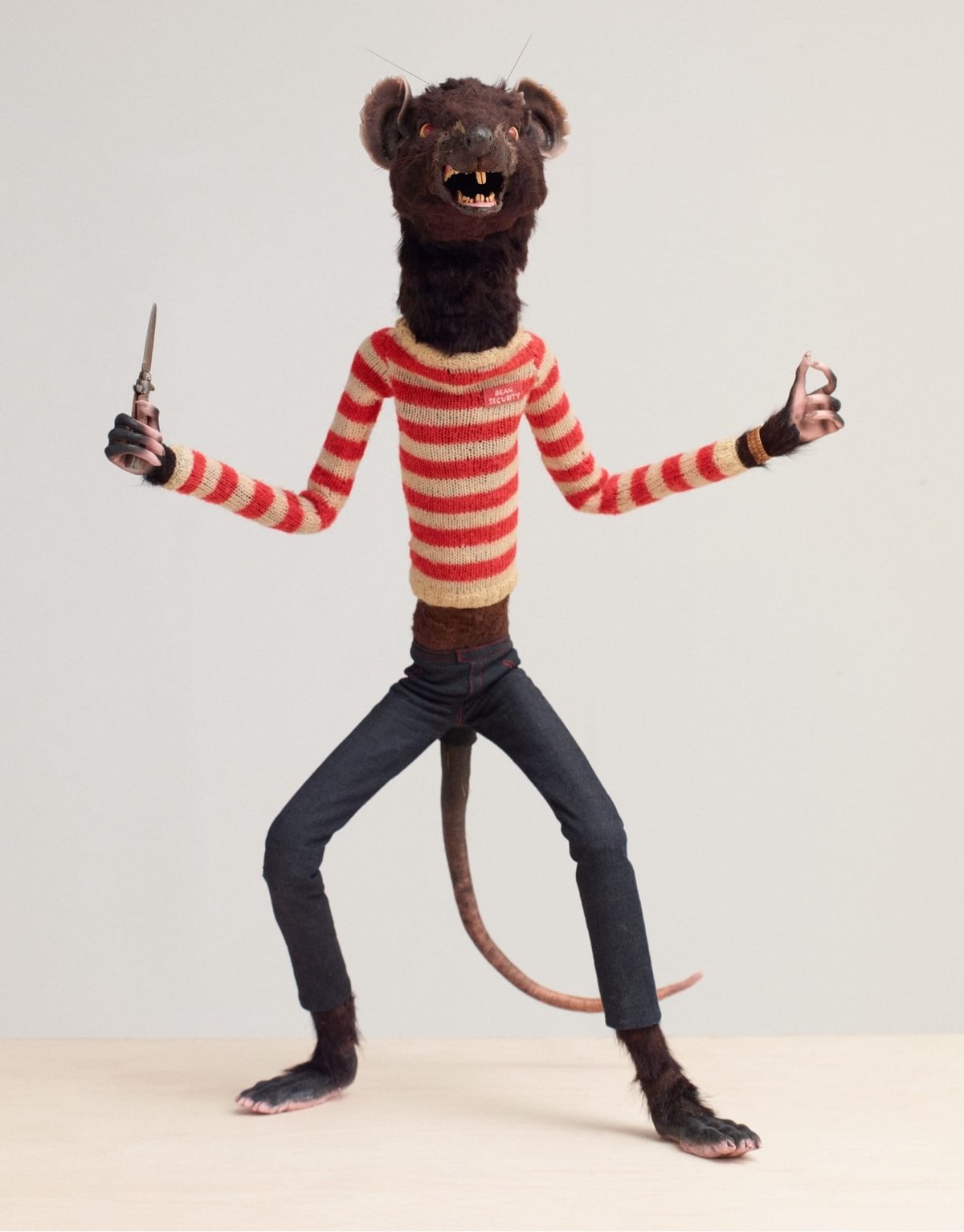 model of a rat holding a knife