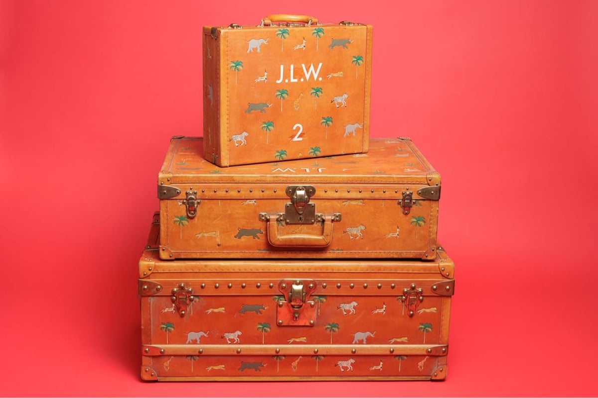 a stack of mongrammed tan luggage