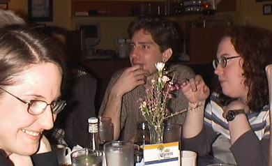 Three people, with flowers.