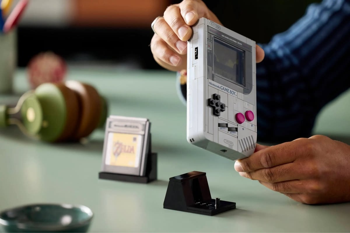 a man holding the Lego Game Boy