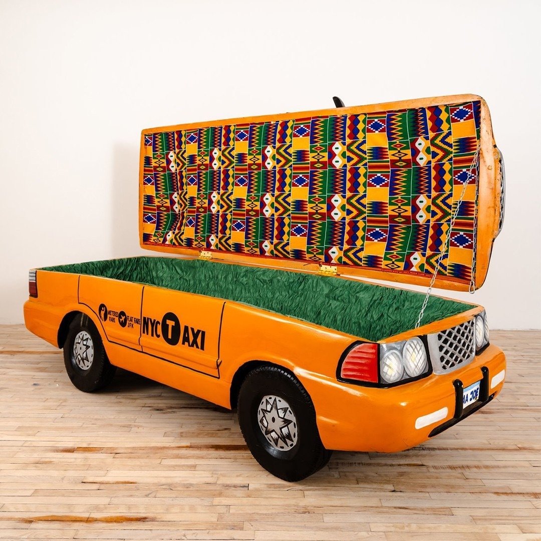 a human-sized coffin shaped like an NYC taxi cab
