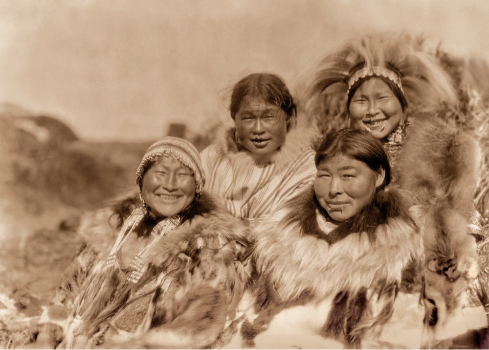 a group of four smiling women