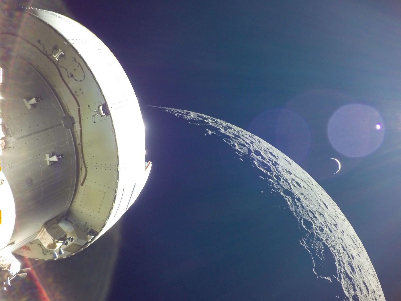 photo of the Moon and Earth with the Artemis I spacecraft in the foreground