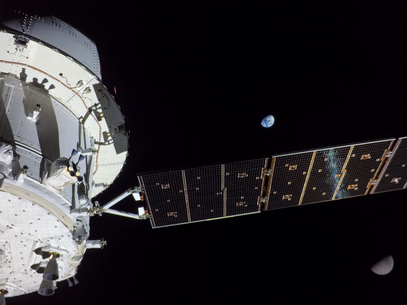 photo of the Moon and Earth with the Artemis I spacecraft in the foreground
