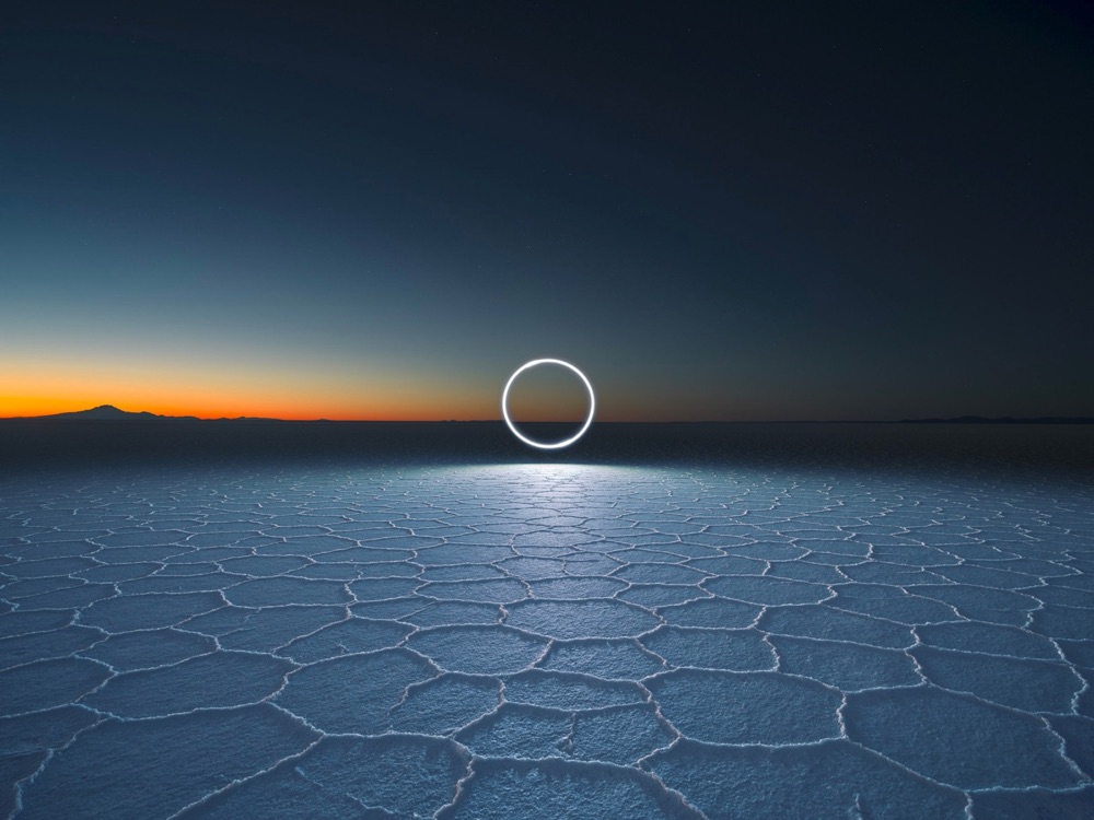 a circle of light over a salt flat