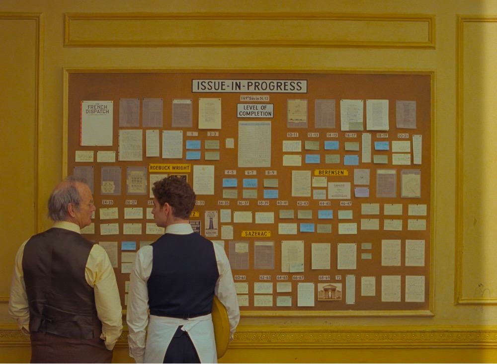a film still from the French Dispatch showing a magazine scheduling flowchart