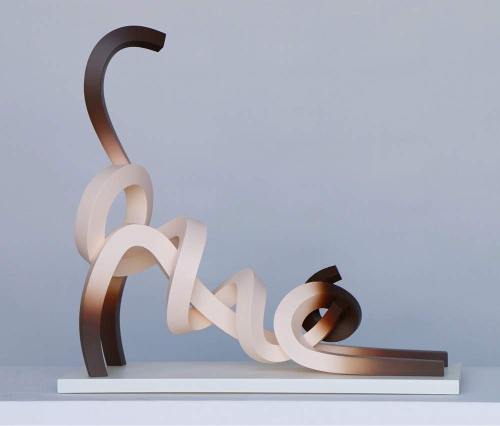 minimalist metal sculpture of a siamese cat