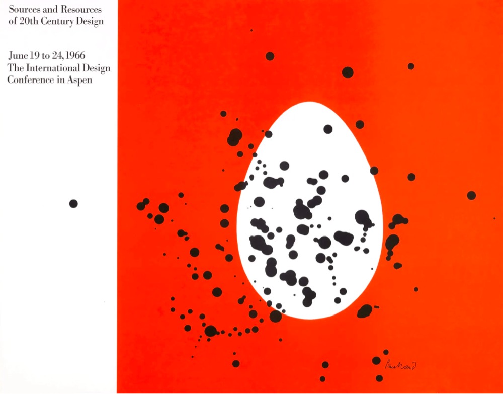 poster with a white oval and black paint splatters on an orange background